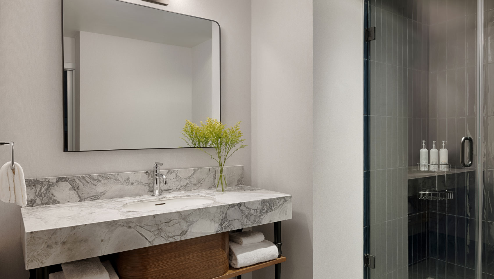 Corner King bathroom sink and shower at Kimpton Hotel Monaco Seattle