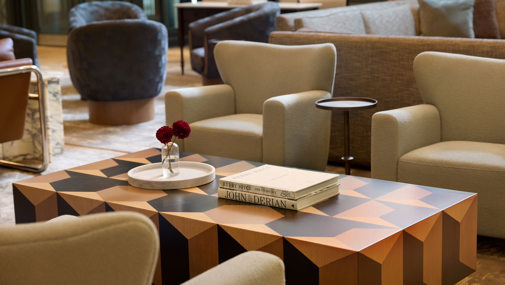 Close-up of lobby seating at Kimpton Hotel Monaco Seattle with coffee table and art books